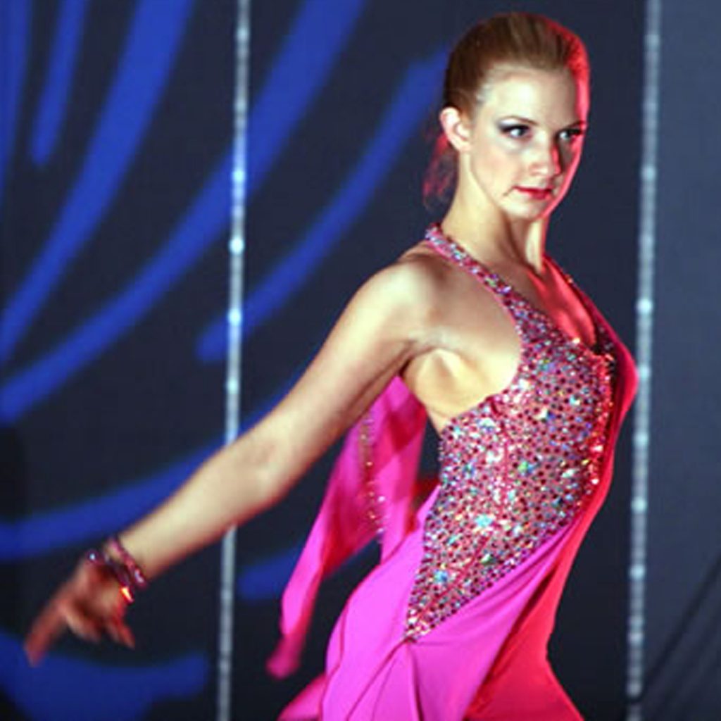 Christina Musser, head instructor at Spotlight Ballroom, wears a Latin dance dress, consistent dress design made by Teresa Sigmon