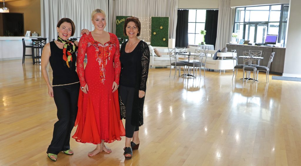 Pretty, Practical Smooth gown with rhinestoned focal point and mesh sleeves, stretch lace. Filmed at Overland Park Ballroom in Kansas. Amy Castro. Carlye Hemphill.
