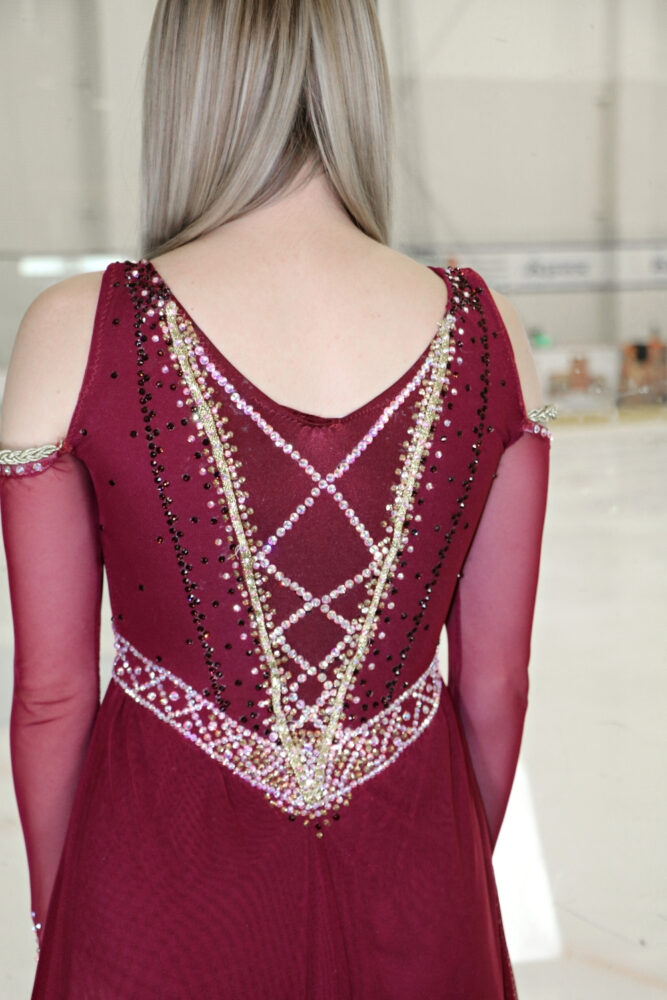 closeup of criss cross rhinestone design on burgundy juliet dress