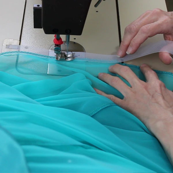 Teresa Sigmon sews crinoline into hem of a ballroom Dancesport line dance dress chiffon sewing machine.  Join the only online, interactive sewing school specifically for making Dancesport, Country and Line Dance dresses for women and teens!