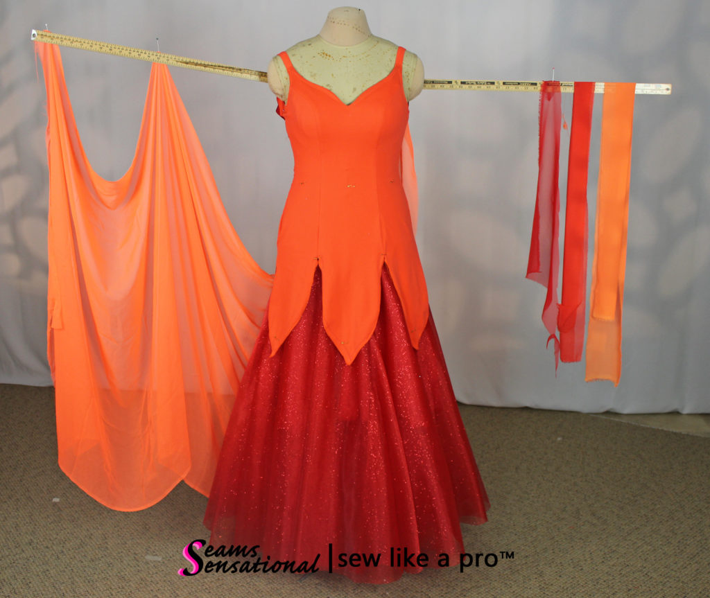 large orange Standard float with multi color drapes on left arm